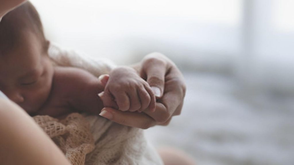 ibu pegang tangan bayi