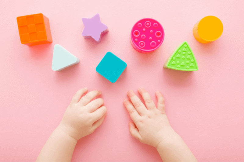 Fisher-Price - child-playing-with-blocks